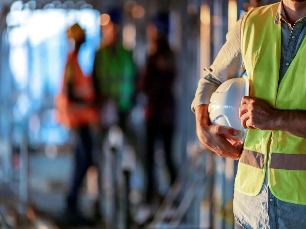A worker holding a hard hat