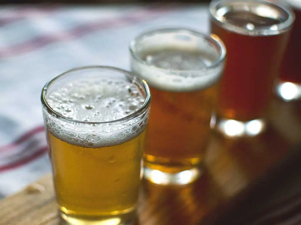 Several glasses of alcohol on top of a table