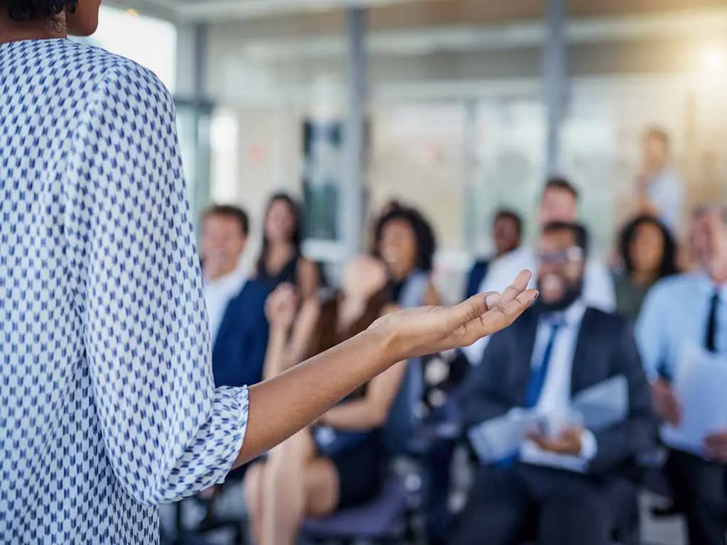 A group of employees listening to a presentation