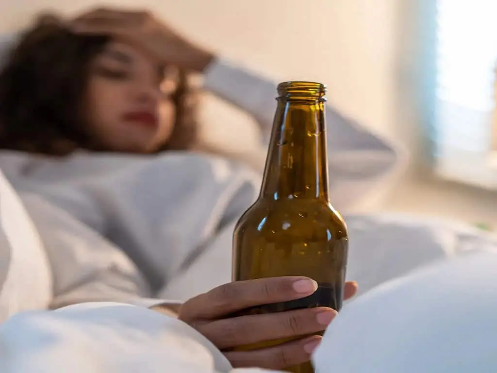 fast alcohol screening test 1 Woman holding a bottle of alcohol in bed