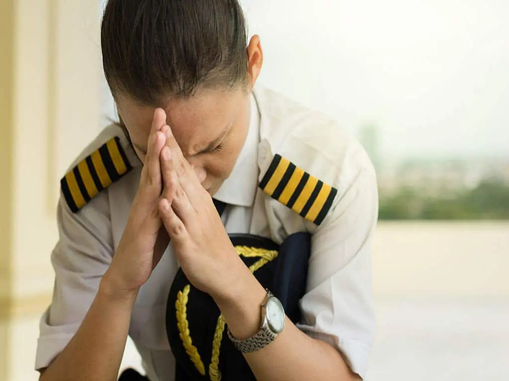 A pilot sitting while thinking hard