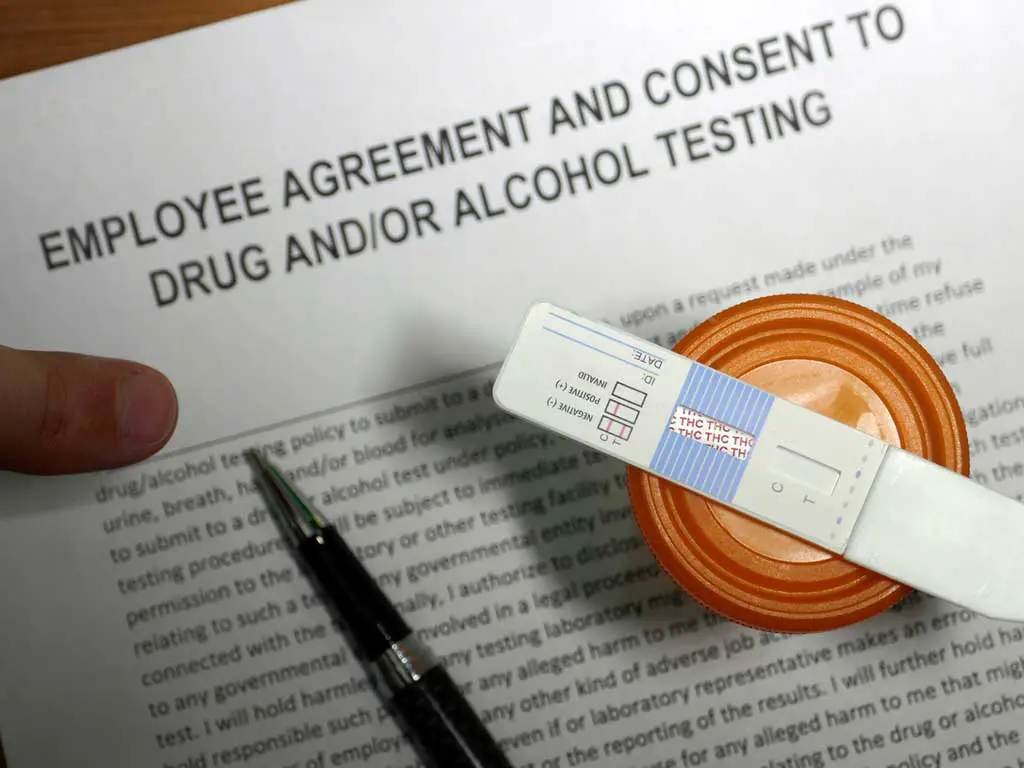 A lab technician holding a vial for testing