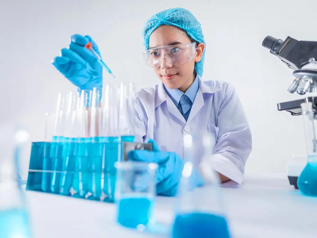 A female technician conducting tests at a lab