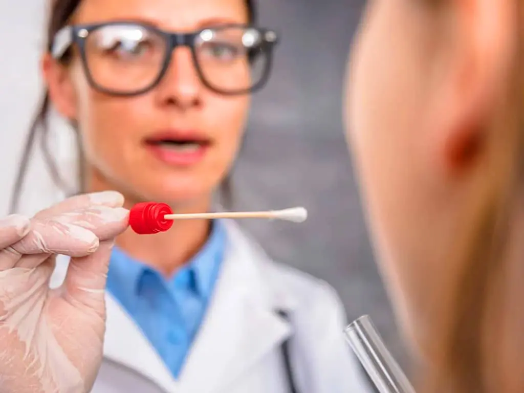 A professional collecting saliva samples