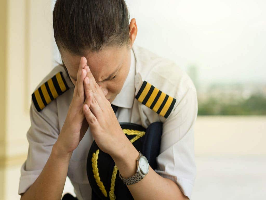 A female officer sitting with eyes closed
