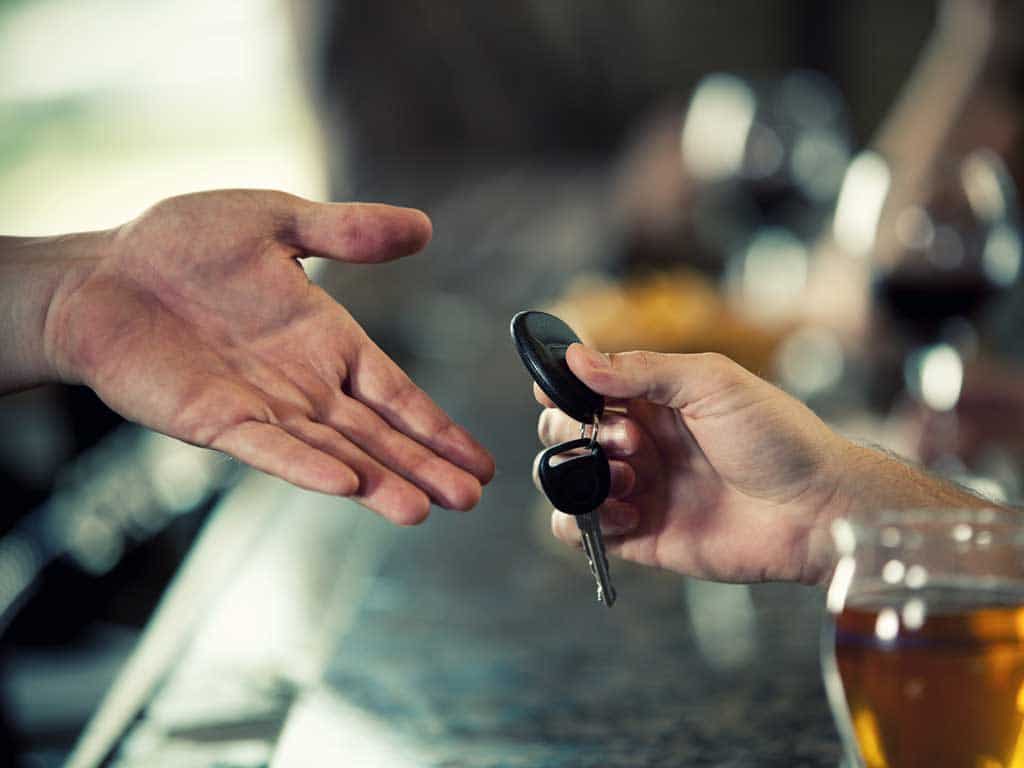 Man in bar getting back his car keys because he is sober