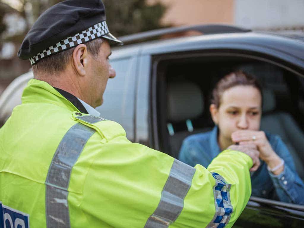 drink driving penalties 2 An Australian police officer conducting a roadside breath test using a breathalyser