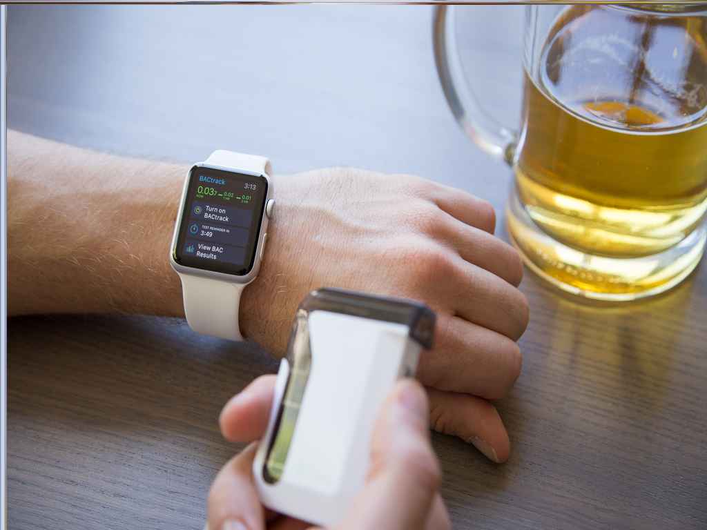 drunk testers 2 A person connecting a smartphone breathalyser to a smartwatch