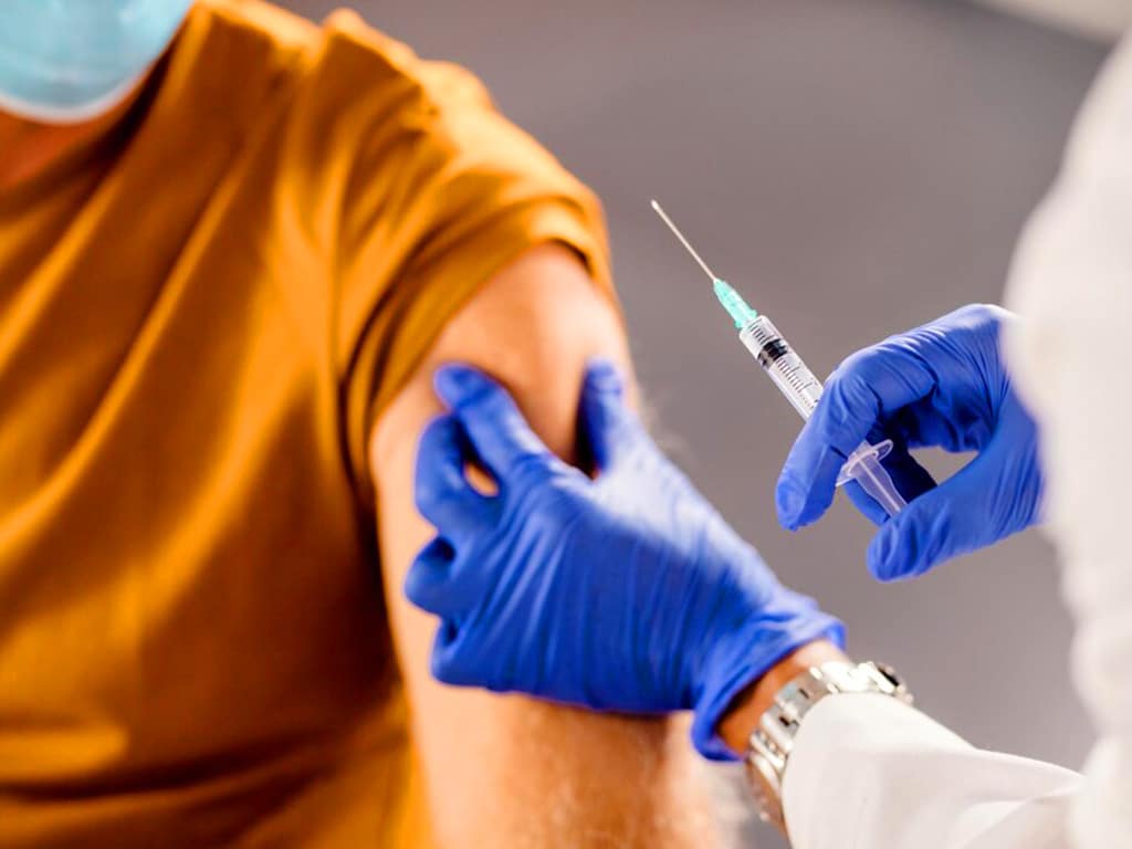 A healthcare professional about to draw blood from a patient