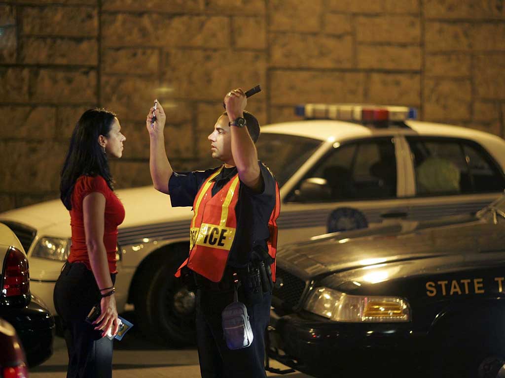 alcohol drug testing what drivers need to know 2 A police officer doing a sobriety test on a woman