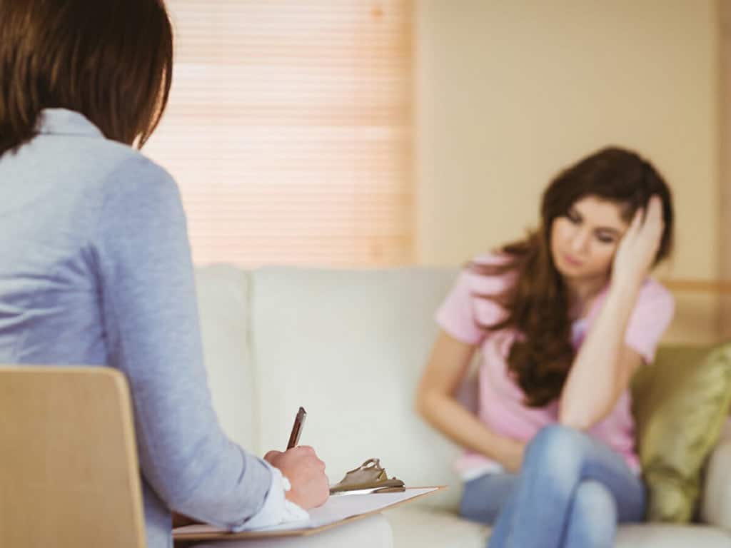 A distressed woman in an interview with a healthcare professional