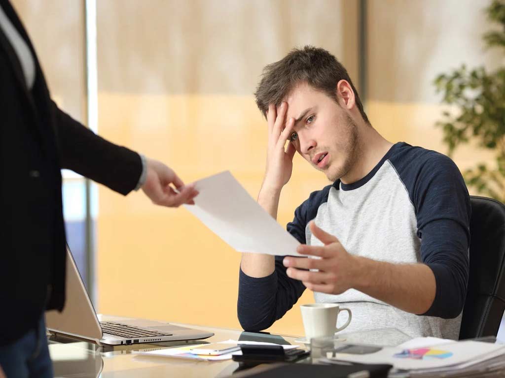 A supervisor handing the results of an alcohol and drug test