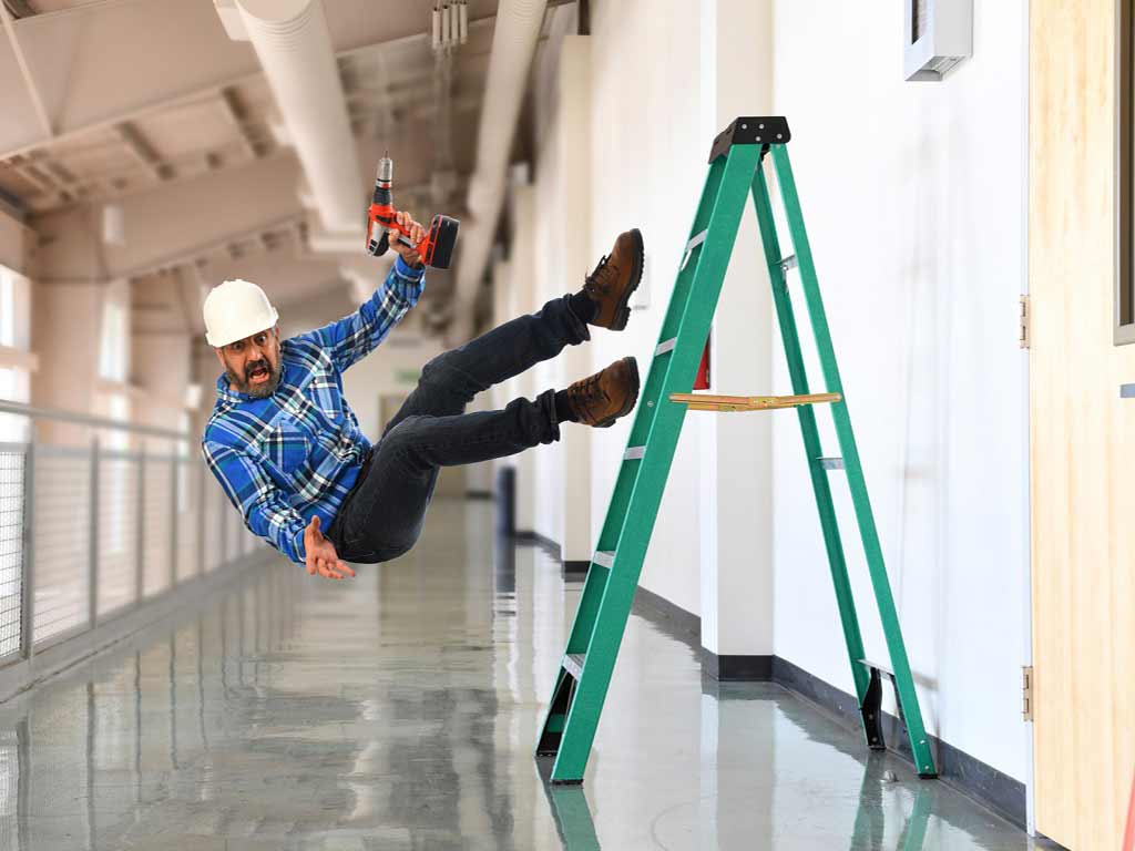 A worker falling from a ladder while working