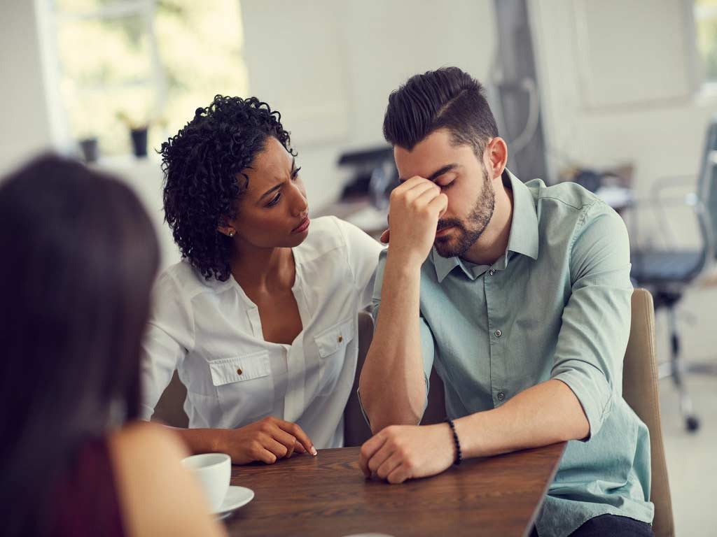 Three people having a group couselling session