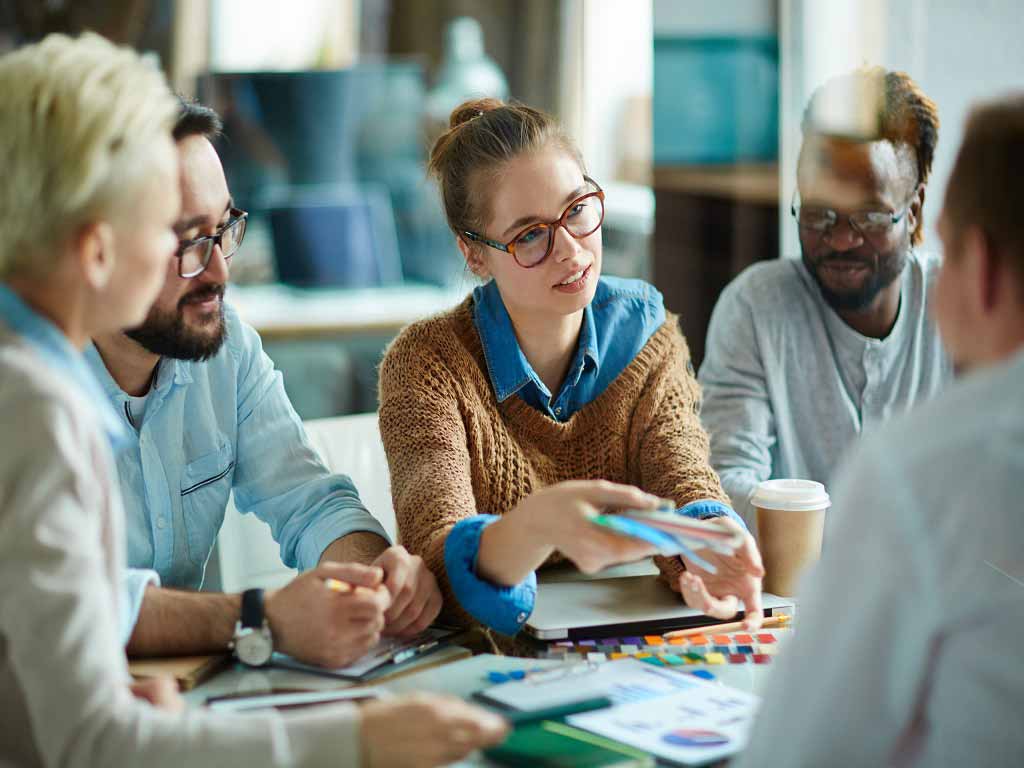 Five employees having a meeting