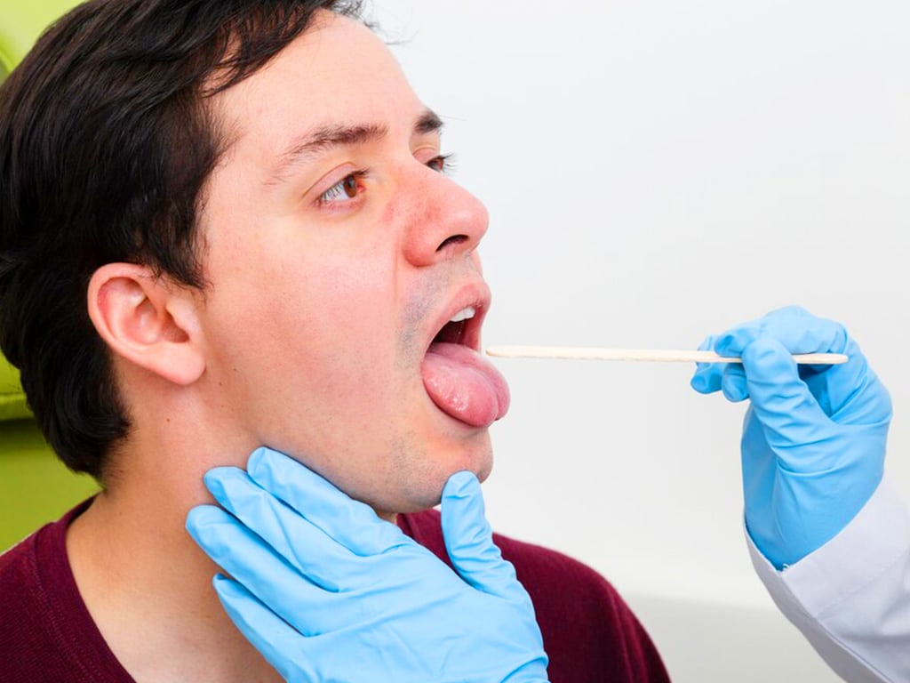 mdma drug test. 1 A medical professional conducting a swab test on male individual