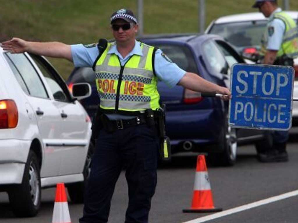 Law enforcement officer performing a roadside traffic stop