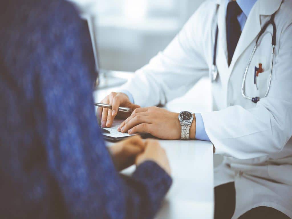 A patient consulting a doctor in a clinic