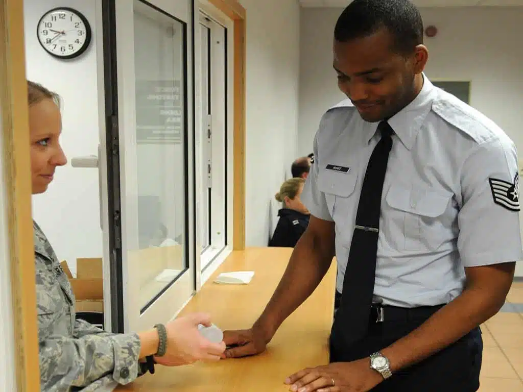 dot drug and alcohol testing. 2 A female officer giving a collection container to a male officer