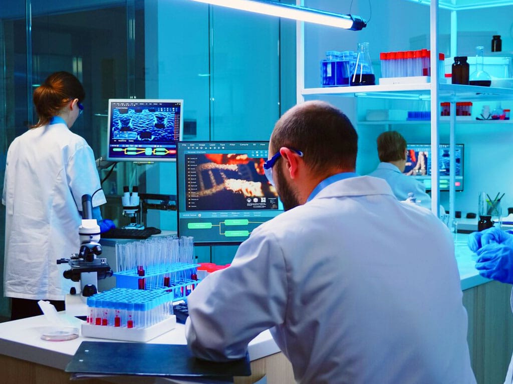 Three professionals working in a laboratory