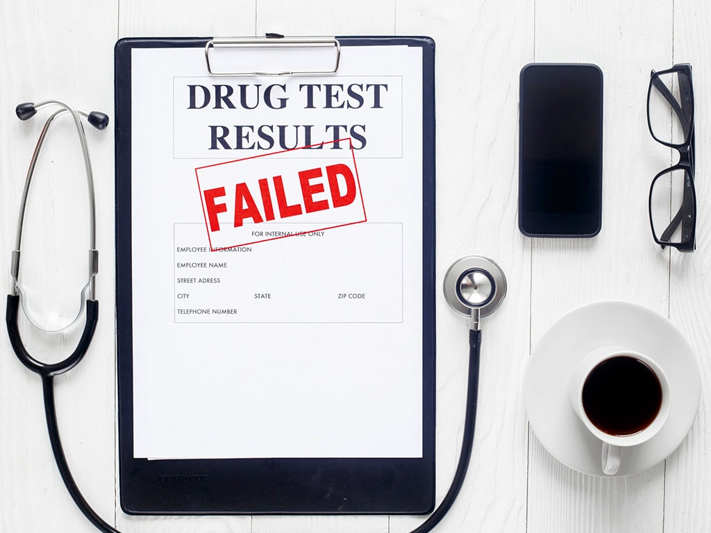 A drug test result on a clipboard with a failed stamp